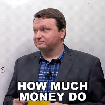 A Man In A Suit And Plaid Shirt Is Holding A Yellow Sticky Note That Says How Much Money Do GIF