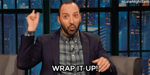 A Man In A Suit And Plaid Shirt Is Sitting On A Couch And Says Wrap It Up . GIF