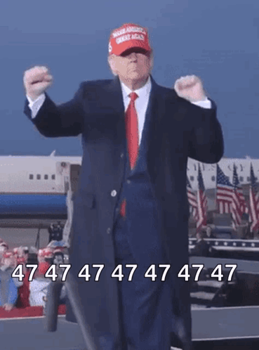A Man In A Suit And Red Tie Is Wearing A Maga Hat And Dancing GIF