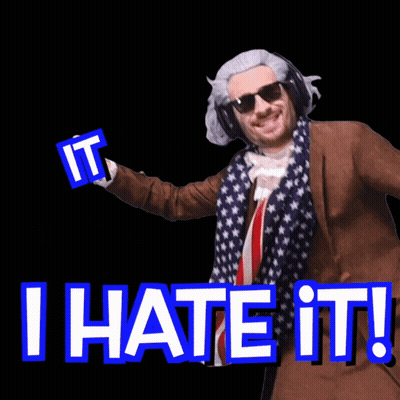 A Man In A Suit And Scarf Is Holding A Sign That Says I Hate It GIF