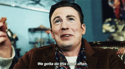 A Man In A Suit And Scarf Is Sitting In A Chair And Saying `` We Gotta Do This More Often '' GIF