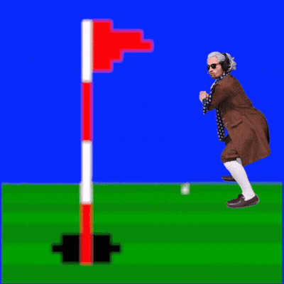 A Man In A Suit And Scarf Is Standing On A Golf Course GIF