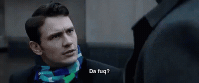 A Man In A Suit And Scarf Is Talking To Another Man In A Suit And Scarf . GIF