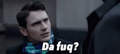 A Man In A Suit And Scarf Is Talking To Another Man While Wearing A Scarf . GIF
