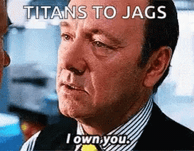 A Man In A Suit And Striped Shirt Is Talking To Another Man With The Caption Titans To Jags I Own You GIF