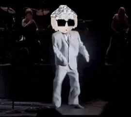 A Man In A Suit And Sunglasses Is Dancing On Stage . GIF