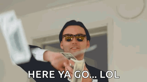 A Man In A Suit And Sunglasses Is Holding A Bunch Of Money In His Hand . GIF