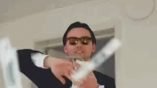 A Man In A Suit And Sunglasses Is Holding A Bunch Of Money In His Hands . GIF