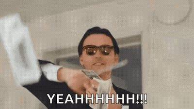 A Man In A Suit And Sunglasses Is Holding A Bunch Of Money . GIF