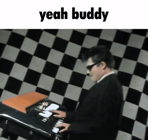 A Man In A Suit And Sunglasses Is Playing A Keyboard With The Words Yeah Buddy Above Him GIF