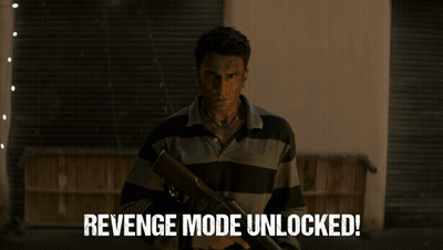 A Man In A Suit And Sunglasses Is Standing In A Hallway With The Words Revenge Mode Unlocked Written Below Him GIF
