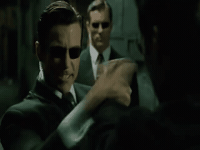 A Man In A Suit And Sunglasses Is Talking To Another Man In A Mirror And Says `` Hm , Upgrades '' . GIF