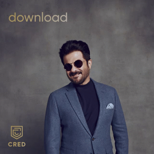 A Man In A Suit And Sunglasses Pointing At The Camera With The Words Download Cred Behind Him GIF