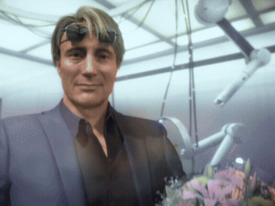 A Man In A Suit And Sunglasses Stands In A Room GIF