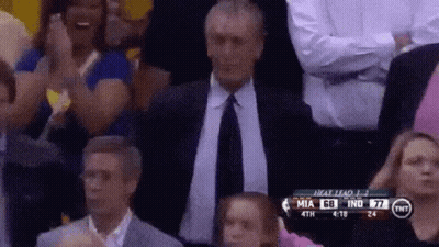 A Man In A Suit And Tie Applauds During A Basketball Game Between Miami And Indiana GIF