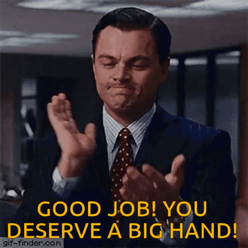 A Man In A Suit And Tie Applauds With The Words " Good Job You Deserve A Big Hand " GIF