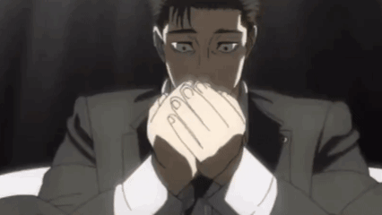 A Man In A Suit And Tie Covering His Mouth With His Hands GIF