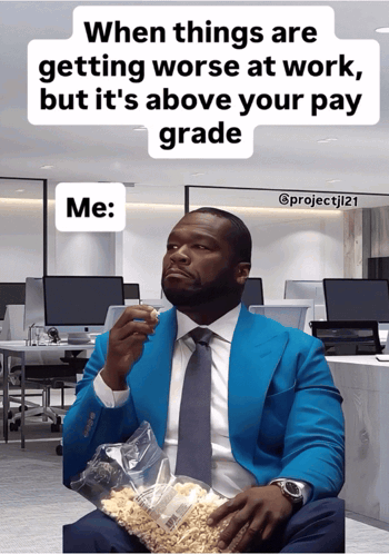 A Man In A Suit And Tie Eating Popcorn With A Caption Saying When Things Are Getting Worse At Work GIF