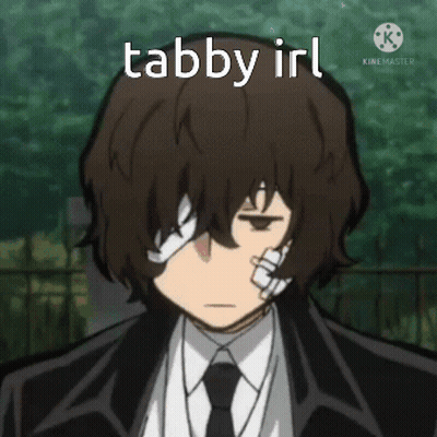 A Man In A Suit And Tie Has A Bandage On His Eye And The Words Tabby Irl Above Him . GIF