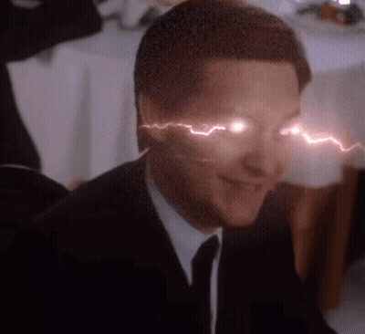 A Man In A Suit And Tie Has A Lightning Bolt Coming Out Of His Eyes GIF