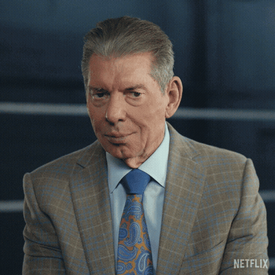 A Man In A Suit And Tie Has A Netflix Logo On His Shoulder GIF