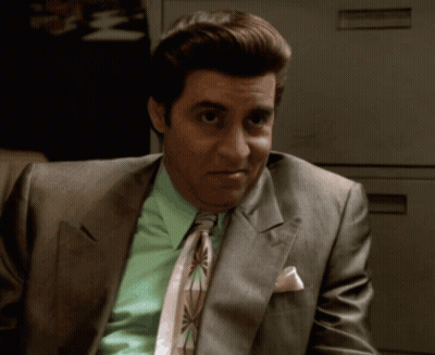 A Man In A Suit And Tie Has A Pink Pocket Square GIF