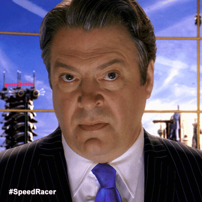 A Man In A Suit And Tie Has The Hashtag #Speedracer On The Bottom Right GIF