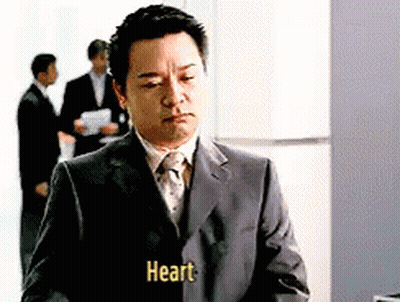 A Man In A Suit And Tie Has The Word Heart Written On His Jacket GIF