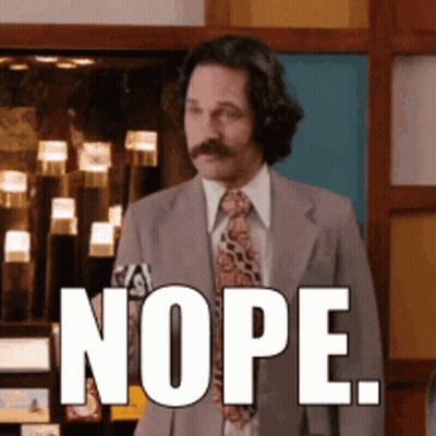 A Man In A Suit And Tie Has The Word Nope On His Face GIF