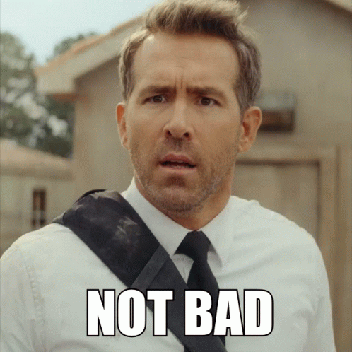 A Man In A Suit And Tie Has The Word Not Bad Written On His Face GIF