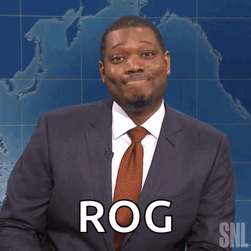 A Man In A Suit And Tie Has The Word Rog On His Chest GIF