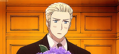 A Man In A Suit And Tie Holding A Bouquet Of Purple Flowers GIF