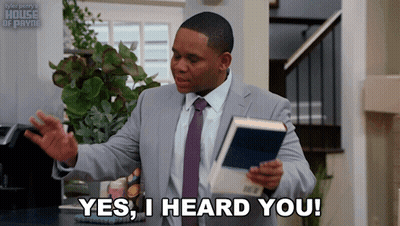 A Man In A Suit And Tie Holds A Book And Says " Yes I Heard You " GIF