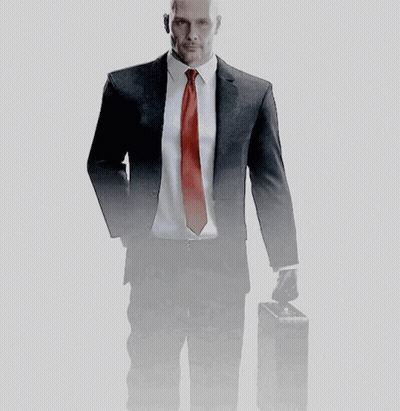 A Man In A Suit And Tie Holds A Briefcase GIF