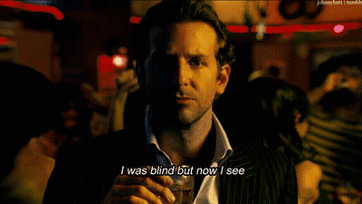 A Man In A Suit And Tie Holds A Glass Of Whiskey And Says I Was Blind But Now I See GIF