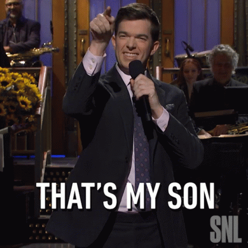 A Man In A Suit And Tie Holds A Microphone And Says That 'S My Son Snl GIF