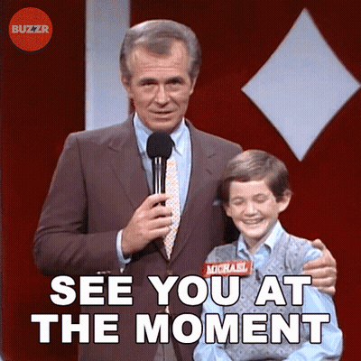A Man In A Suit And Tie Holds A Microphone Next To A Boy With A Name Tag That Says Michael On It GIF