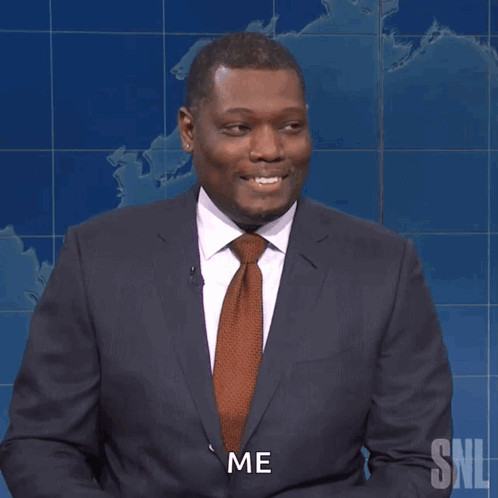 A Man In A Suit And Tie Holds A Pencil And Says Me GIF
