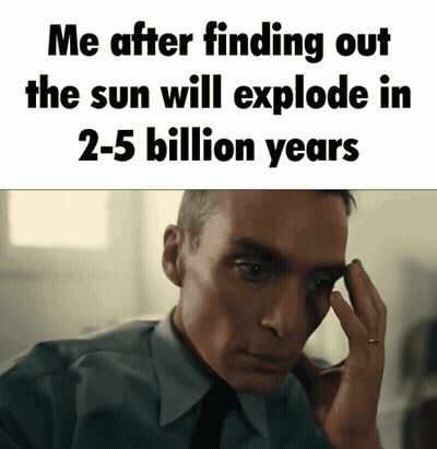 A Man In A Suit And Tie Holds His Hand To His Forehead In Front Of A Sign That Says Me GIF