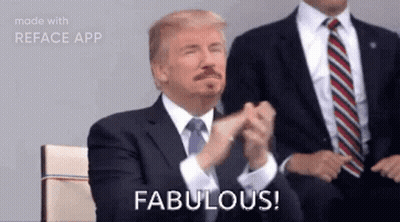 A Man In A Suit And Tie Is Applauding And Says Fabulous . GIF
