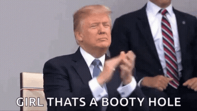 A Man In A Suit And Tie Is Applauding While Sitting Next To Another Man . GIF