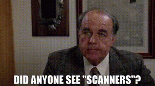 A Man In A Suit And Tie Is Asking If Anyone Has Seen Scanners . GIF