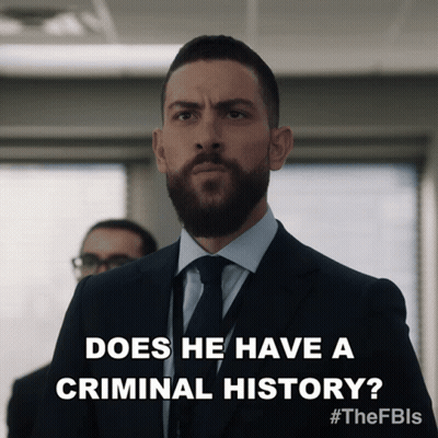 a man in a suit and tie is asking if he has a criminal history