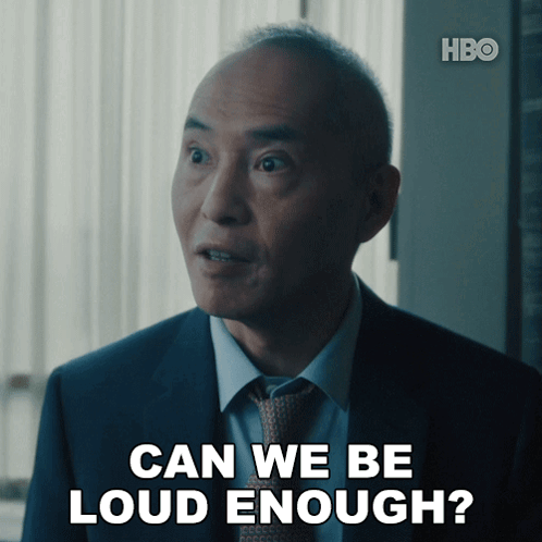A Man In A Suit And Tie Is Asking If He Is Loud Enough GIF
