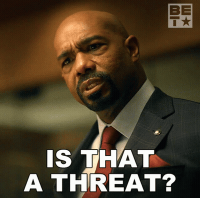 A Man In A Suit And Tie Is Asking If That Is A Threat GIF