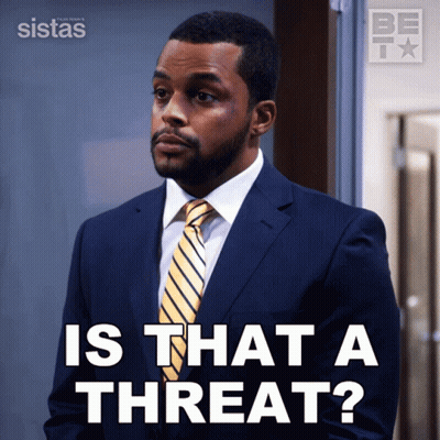 A Man In A Suit And Tie Is Asking If There Is A Threat GIF