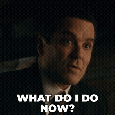 A Man In A Suit And Tie Is Asking What Do I Do Now GIF