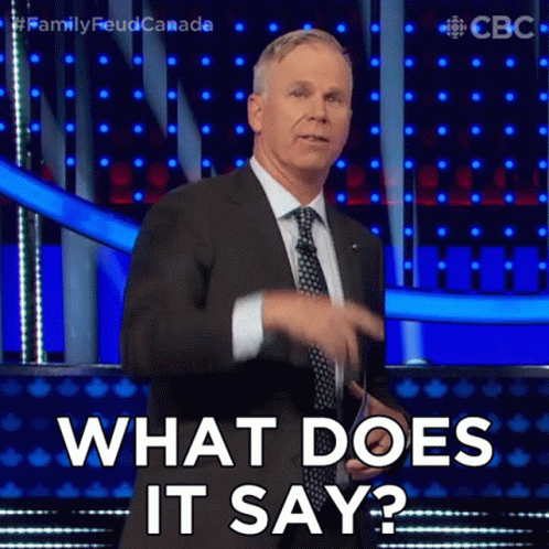 A Man In A Suit And Tie Is Asking What Does It Say GIF