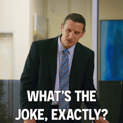 A Man In A Suit And Tie Is Asking " What 'S The Joke Exactly " GIF