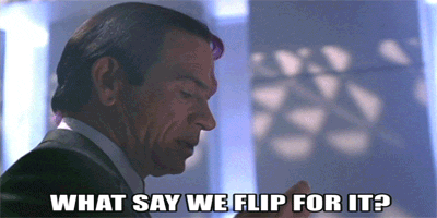 A Man In A Suit And Tie Is Asking What Say We Flip For It GIF